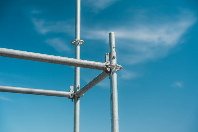Silver scaffolding against a bright blue sky